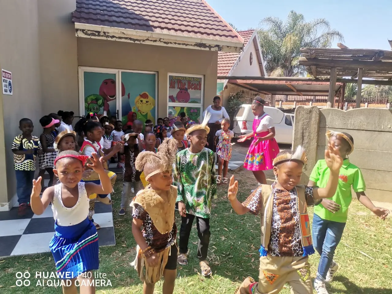 Day care learners wearing traditional clothing, showing excitement about going to play into the garden