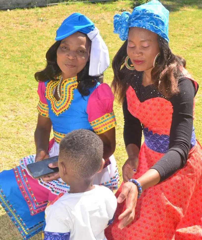 Two of the Chosen Angel Centre preschool teachers and a learner posing for a photo